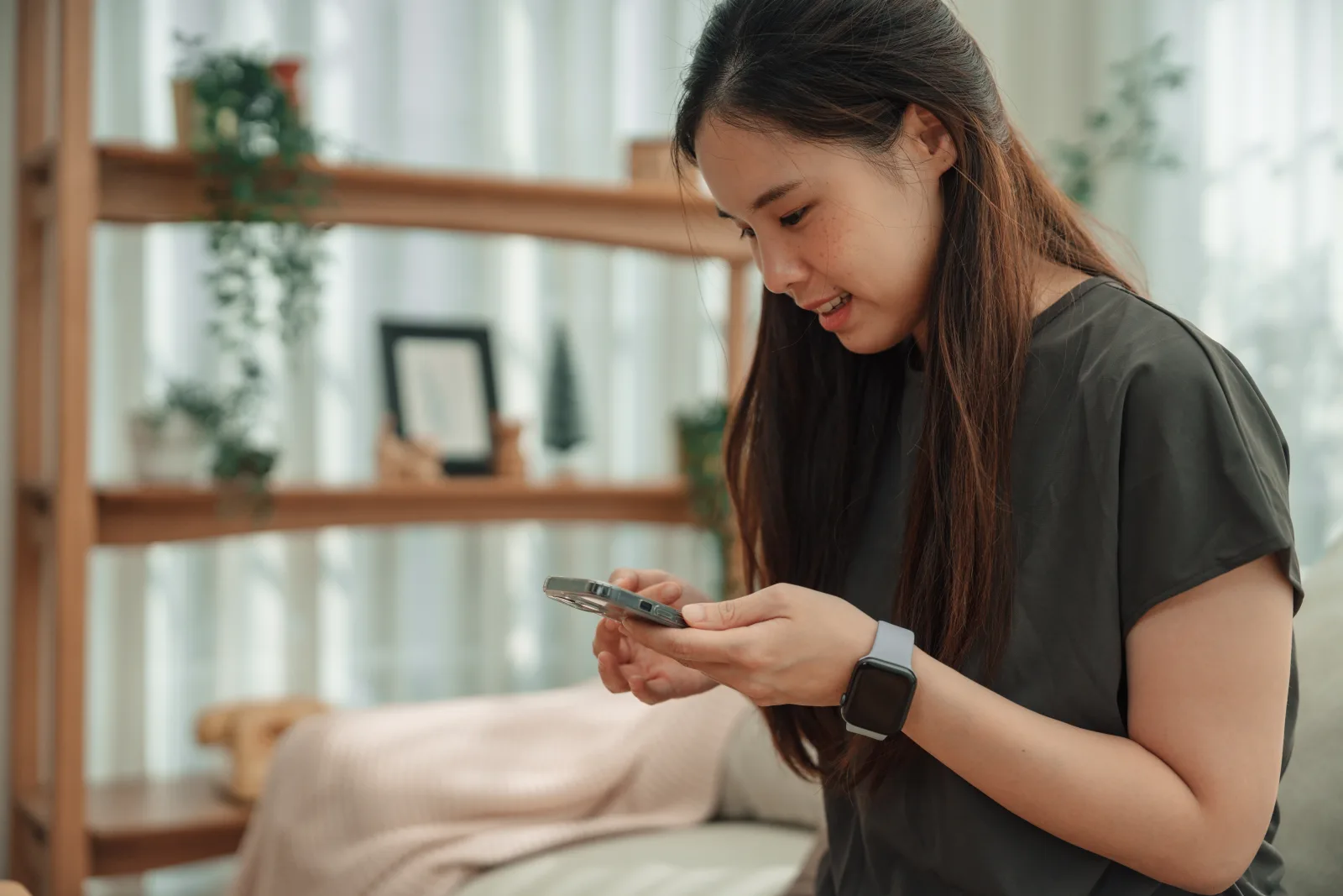 A woman checking her health results on her phone at home